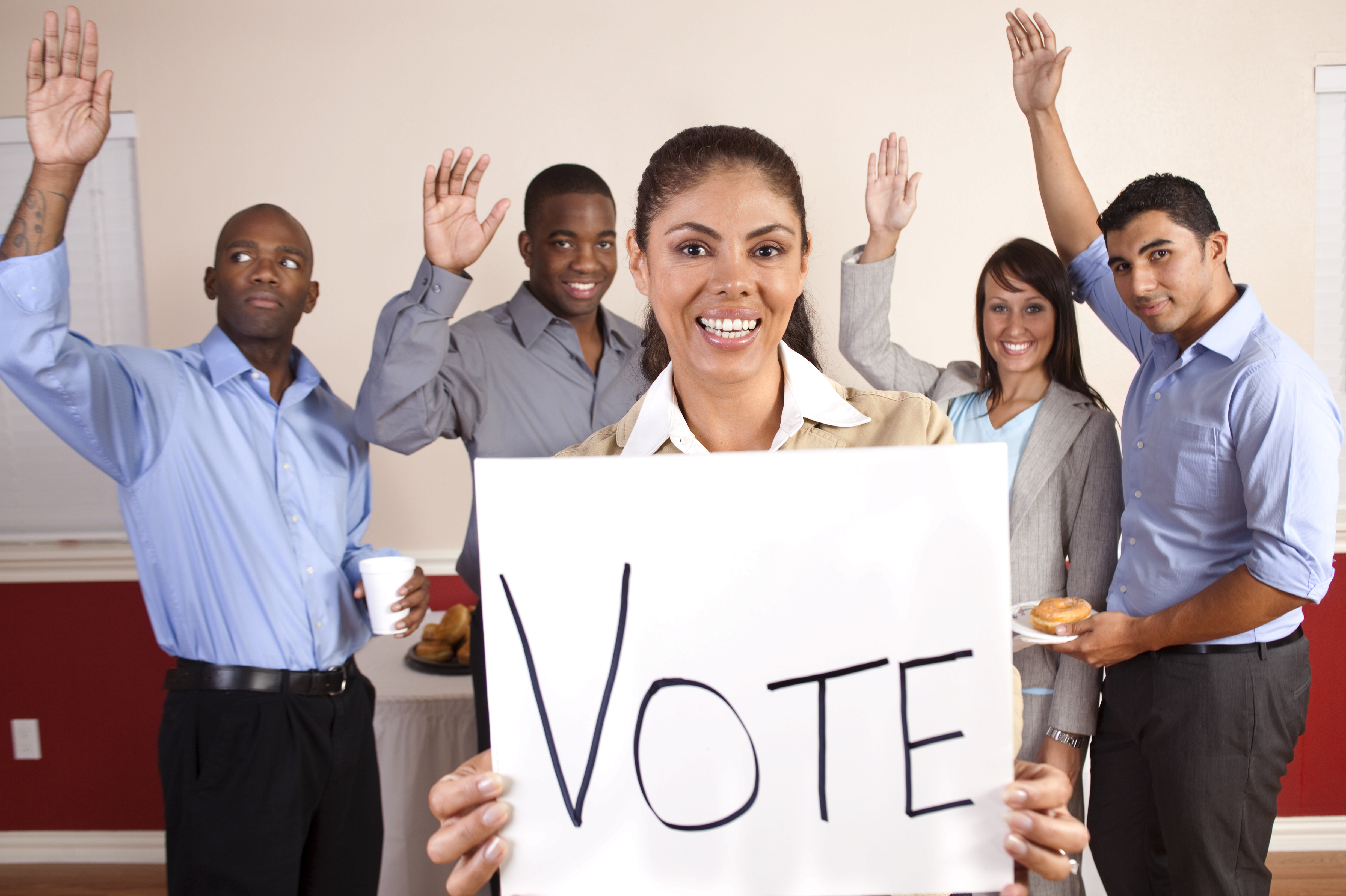 Mixed Ethnic Group of Young Adults with Vote Sign