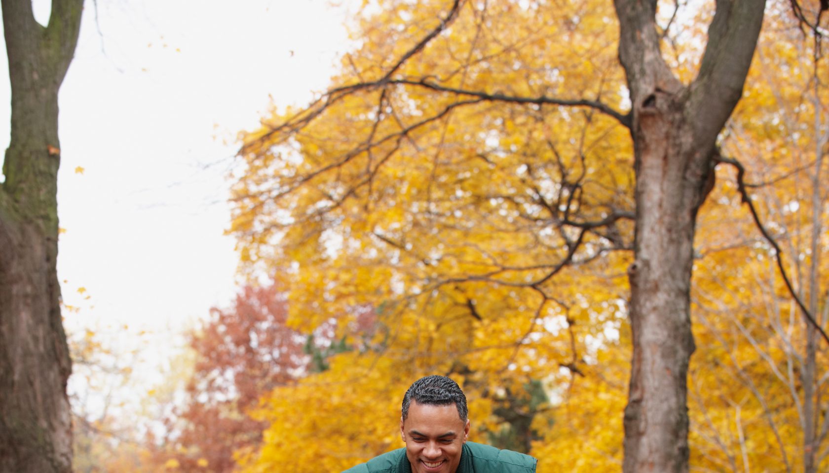 African American man pushing wife in wheelbarrow