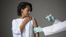 Mid adult woman receiving injection