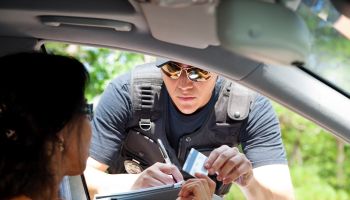Crime: Policeman gives driver a traffic ticket.