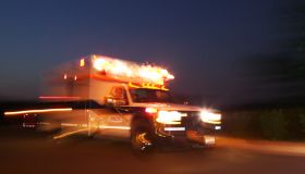 Motion blurred image of an ambulance speeding past the viewer