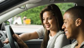 Smiling young couple in a car