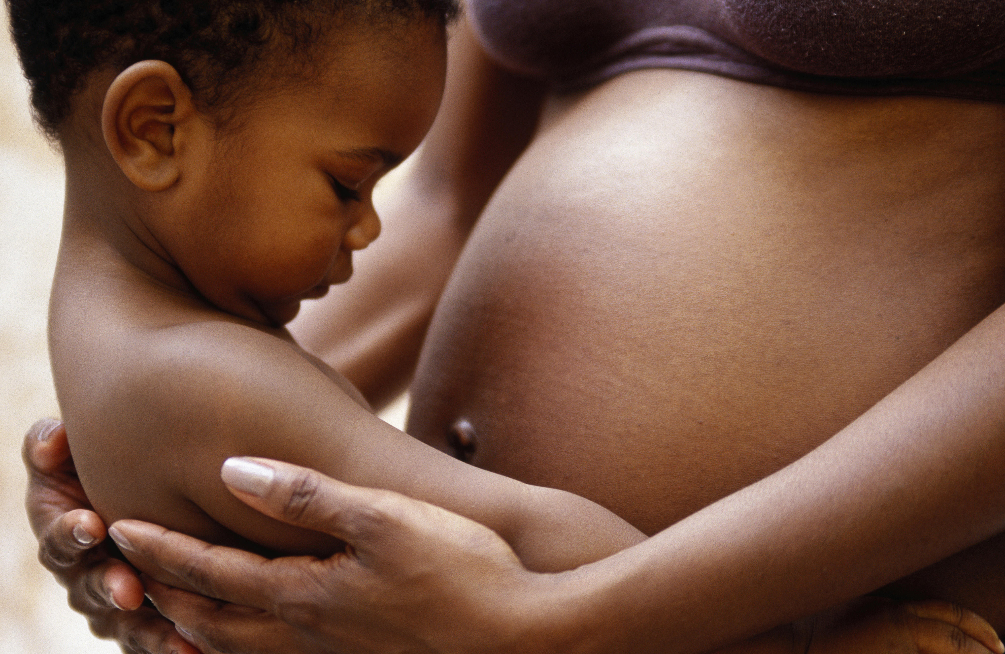 black pregnant woman with baby