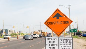 Construction ahead sign next to construction zone with...