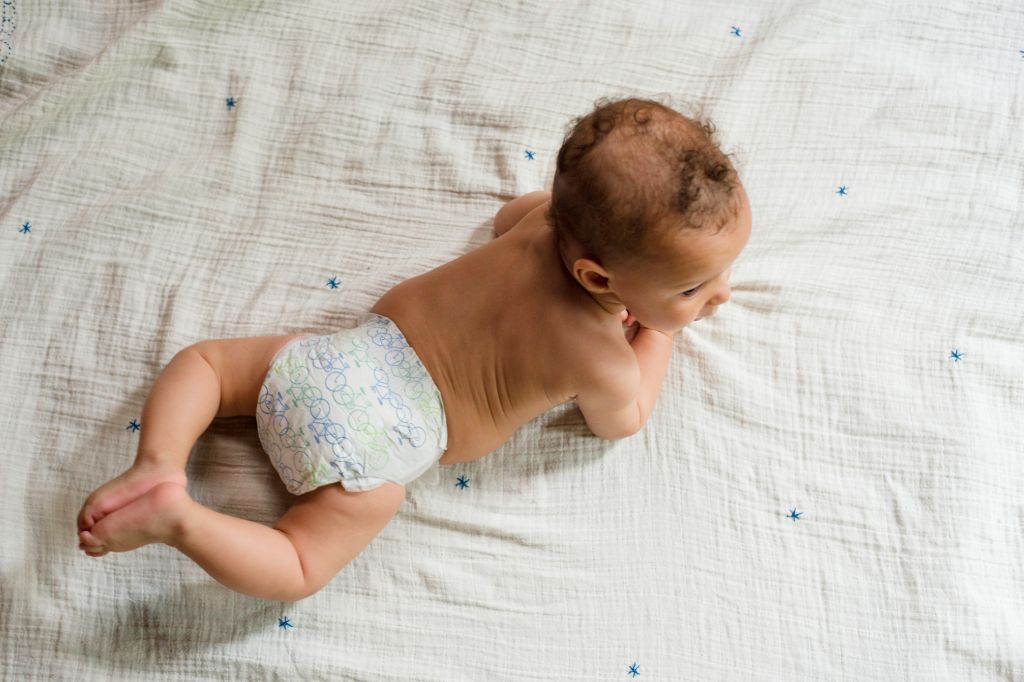 Baby boy lying on stomach, overhead view