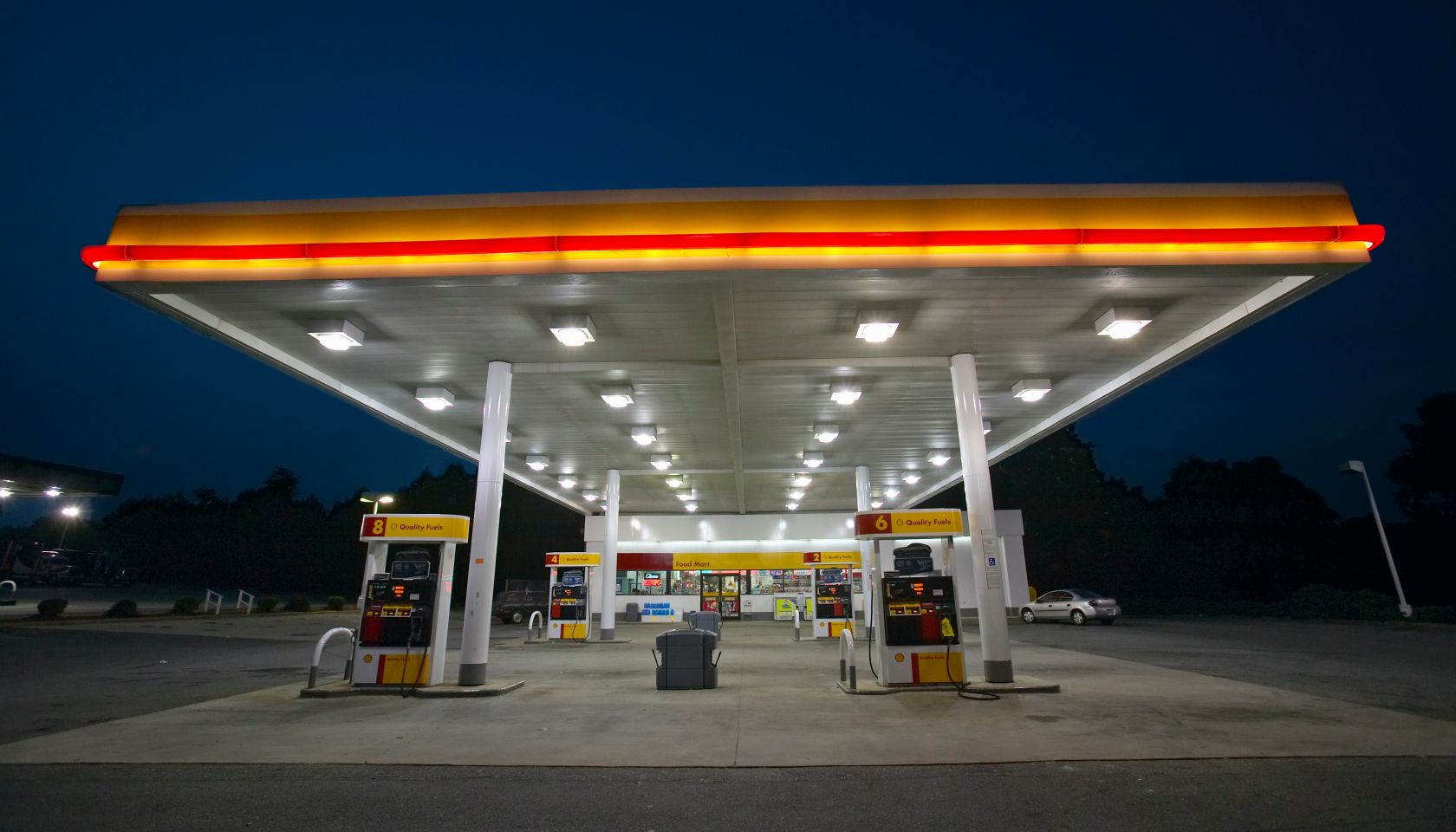 Gas Station with lights on and mini-mart at dusk in Central GA