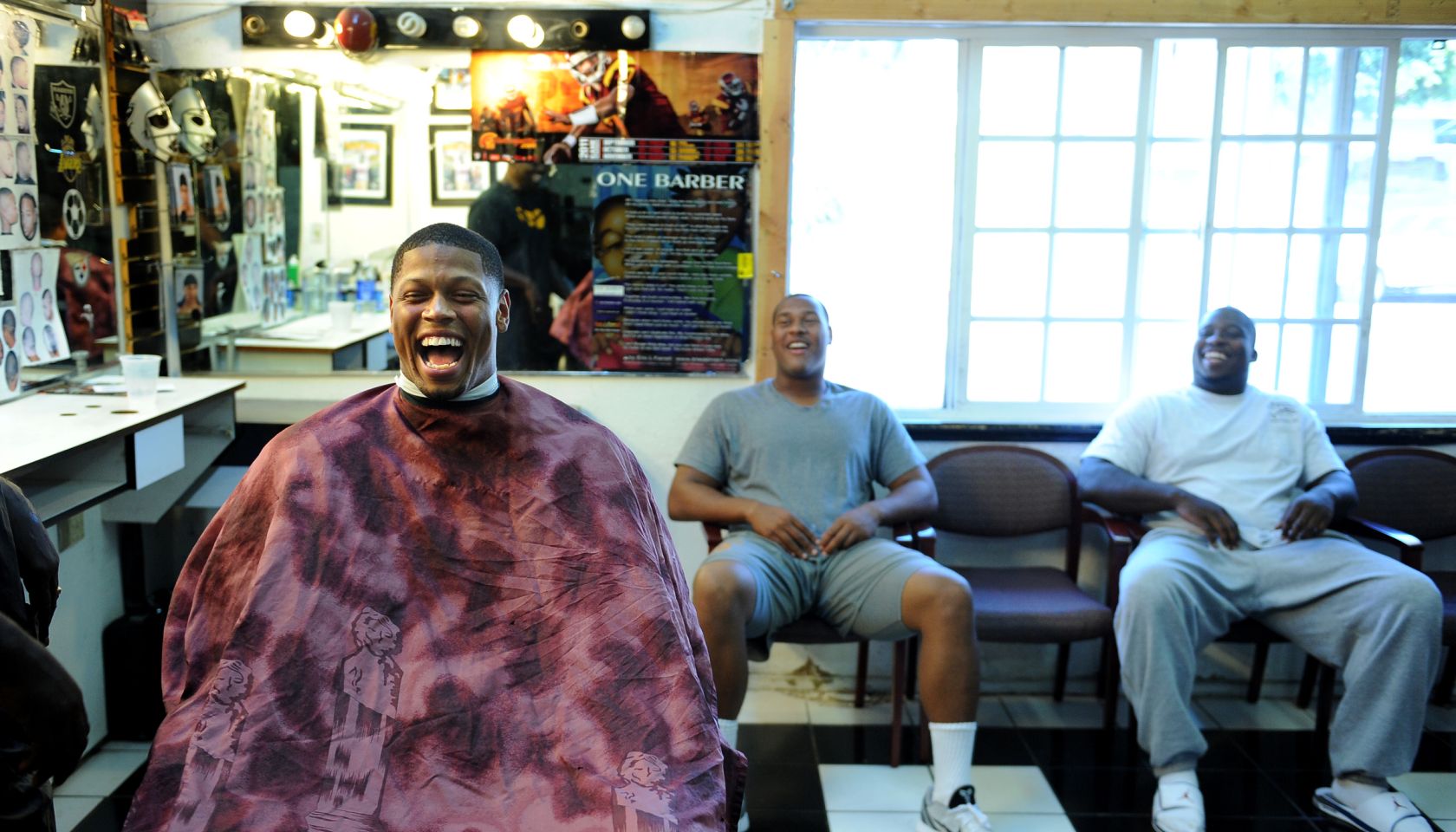 USC defensive end Nick Perry, left, shares a laugh with fellow linemen Armond Armstead and DaJohn H