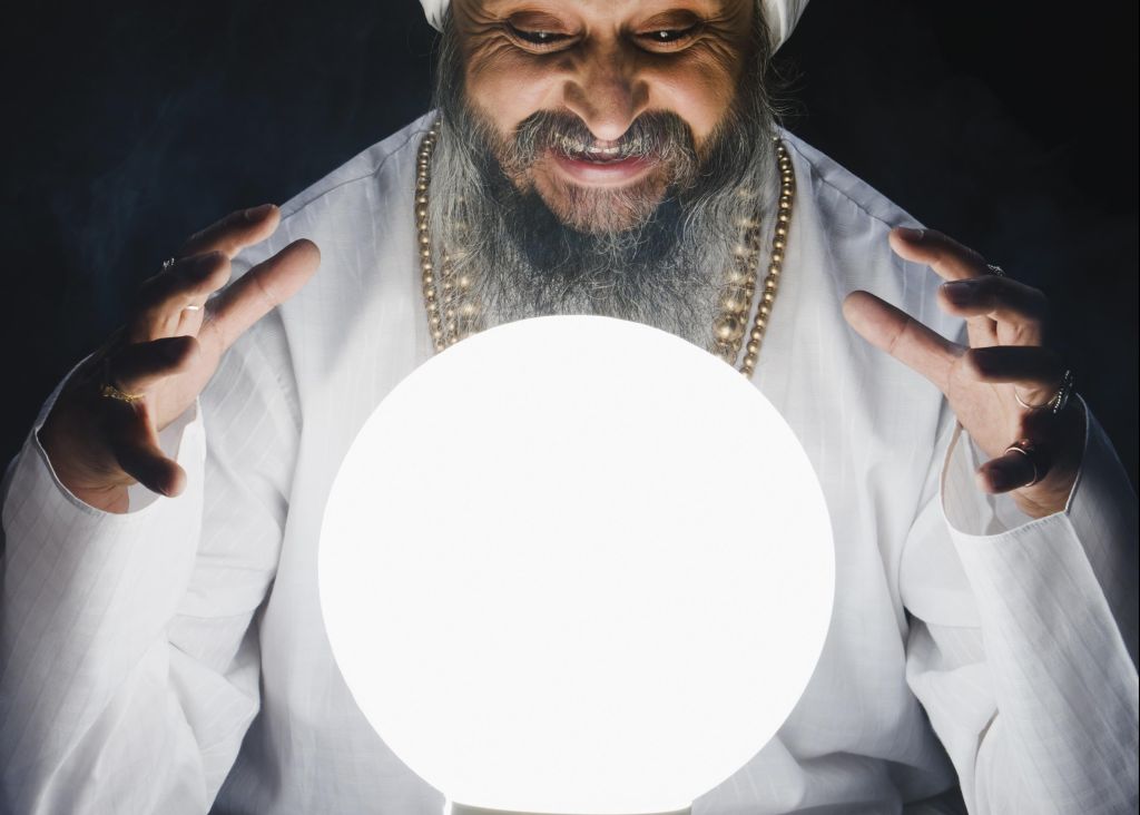 Male fortune teller and crystal ball