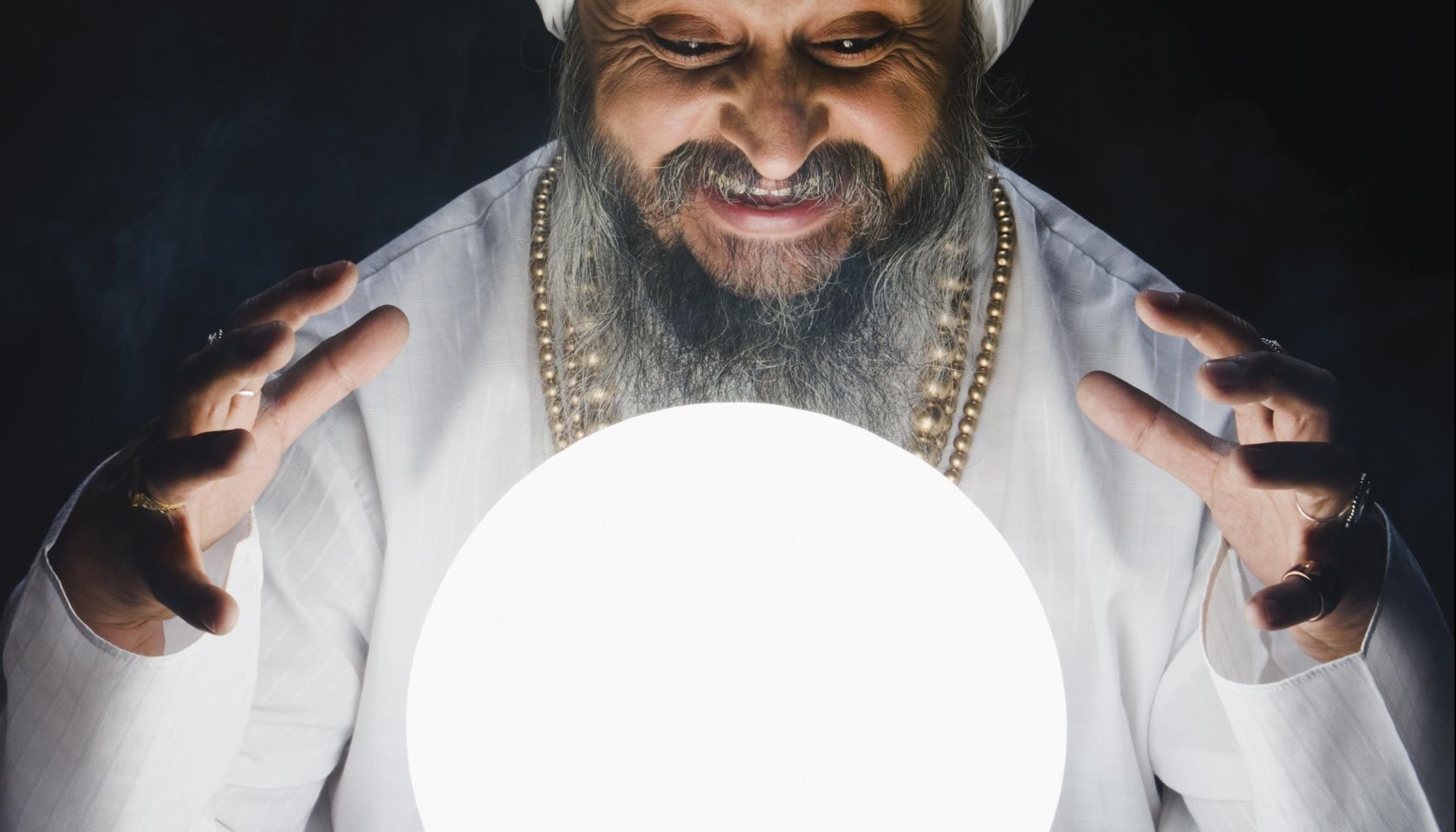 Male fortune teller and crystal ball