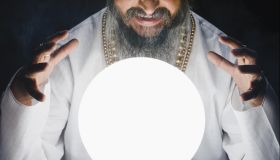 Male fortune teller and crystal ball