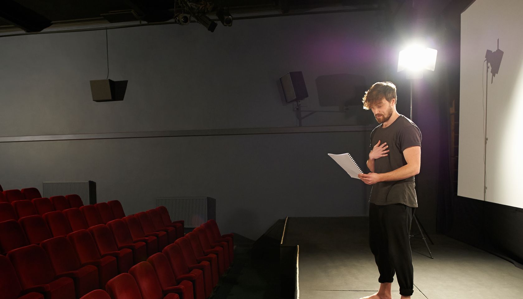 Actor rehearsing his lines on stage.
