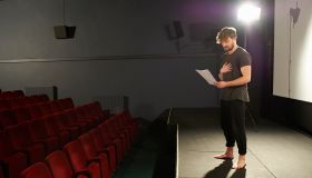 Actor rehearsing his lines on stage.