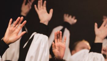 Church Choir's Hands Raised
