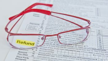 Tax form and eyeglasses