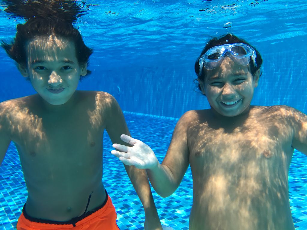 Kids enjoying under water during summer vacation