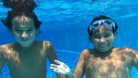 Kids enjoying under water during summer vacation