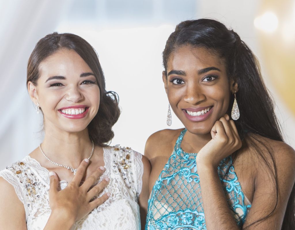 Two multi-ethnic teenage girls dressed for special event