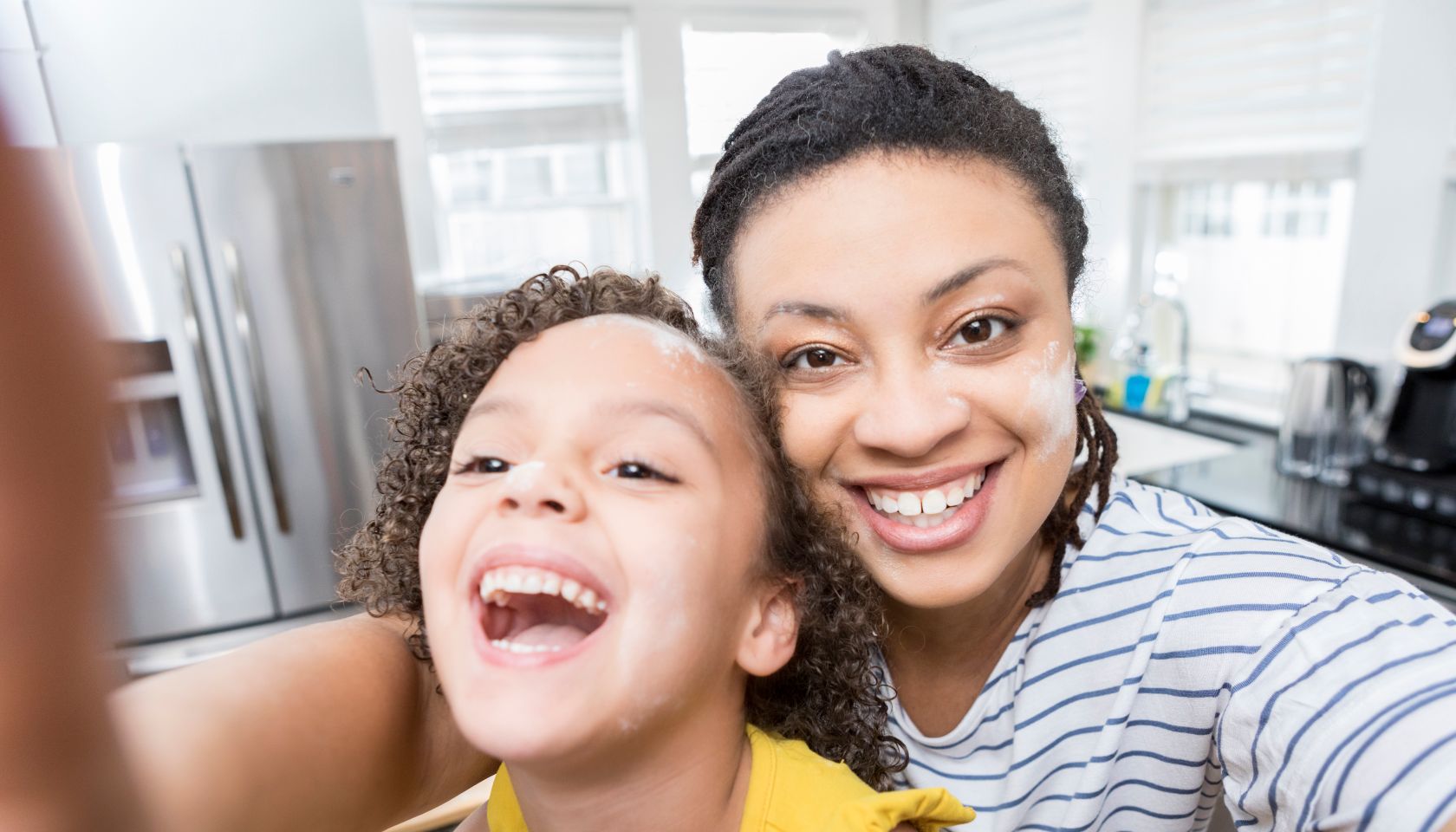 Mom and daughter take selfie at home