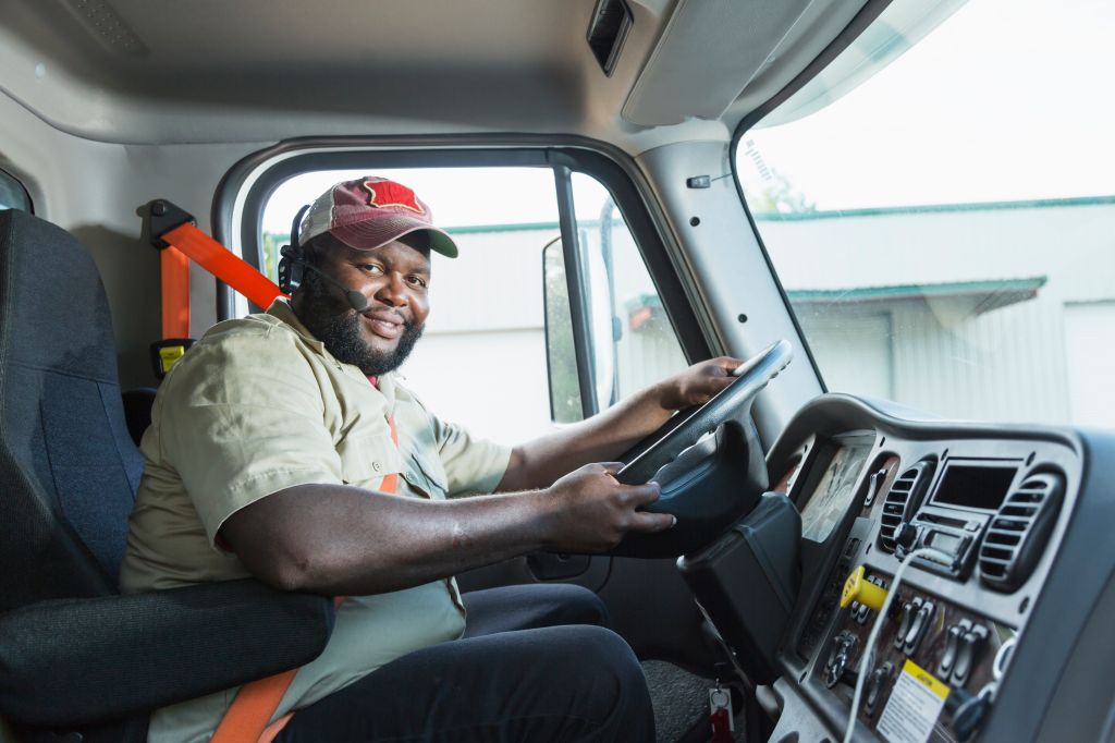 African-American truck driver in driver's seat