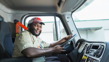 African-American truck driver in driver's seat