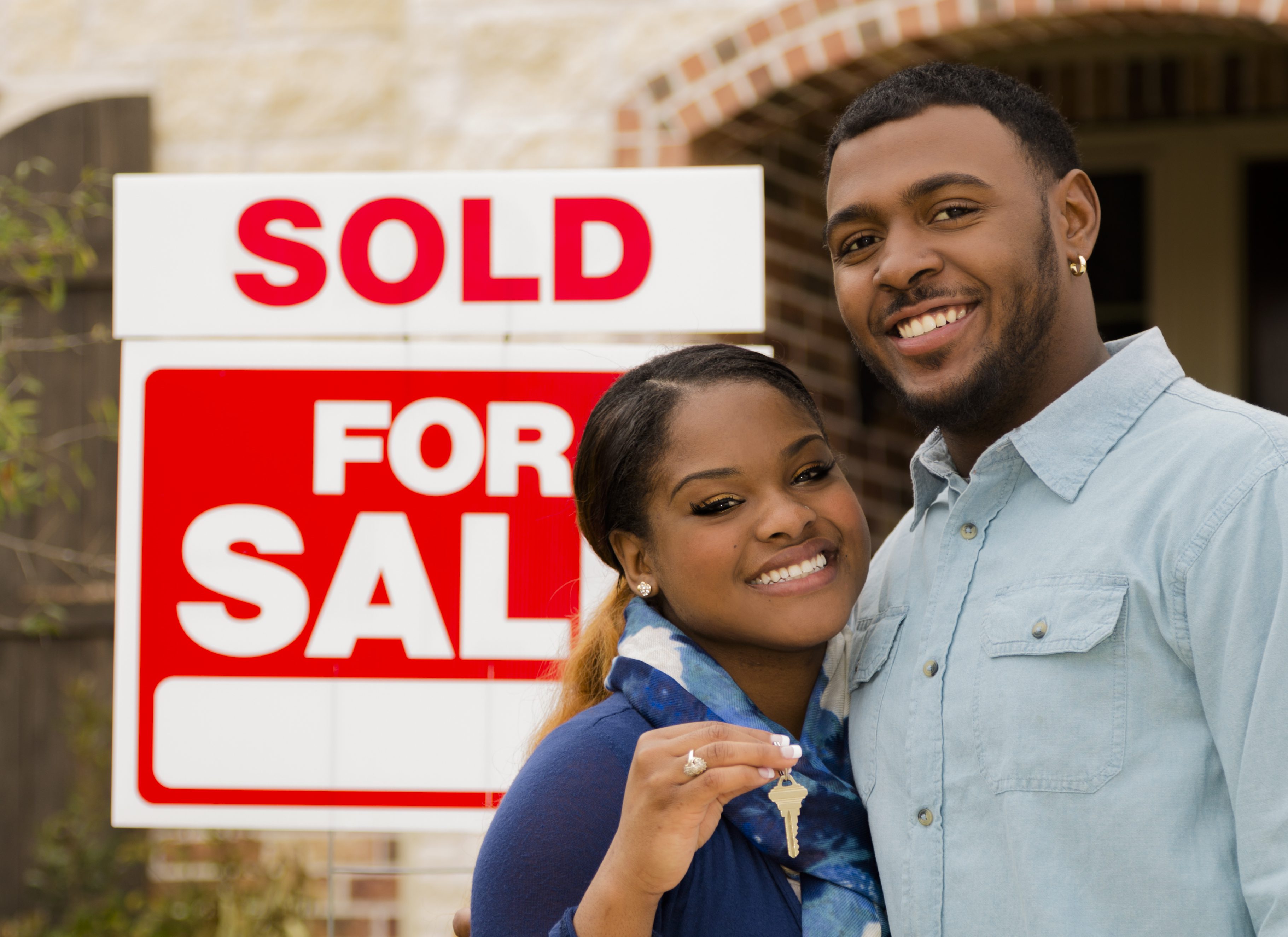 Real Estate: African descent couple buys first home. House key.