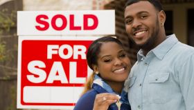 Real Estate: African descent couple buys first home. House key.