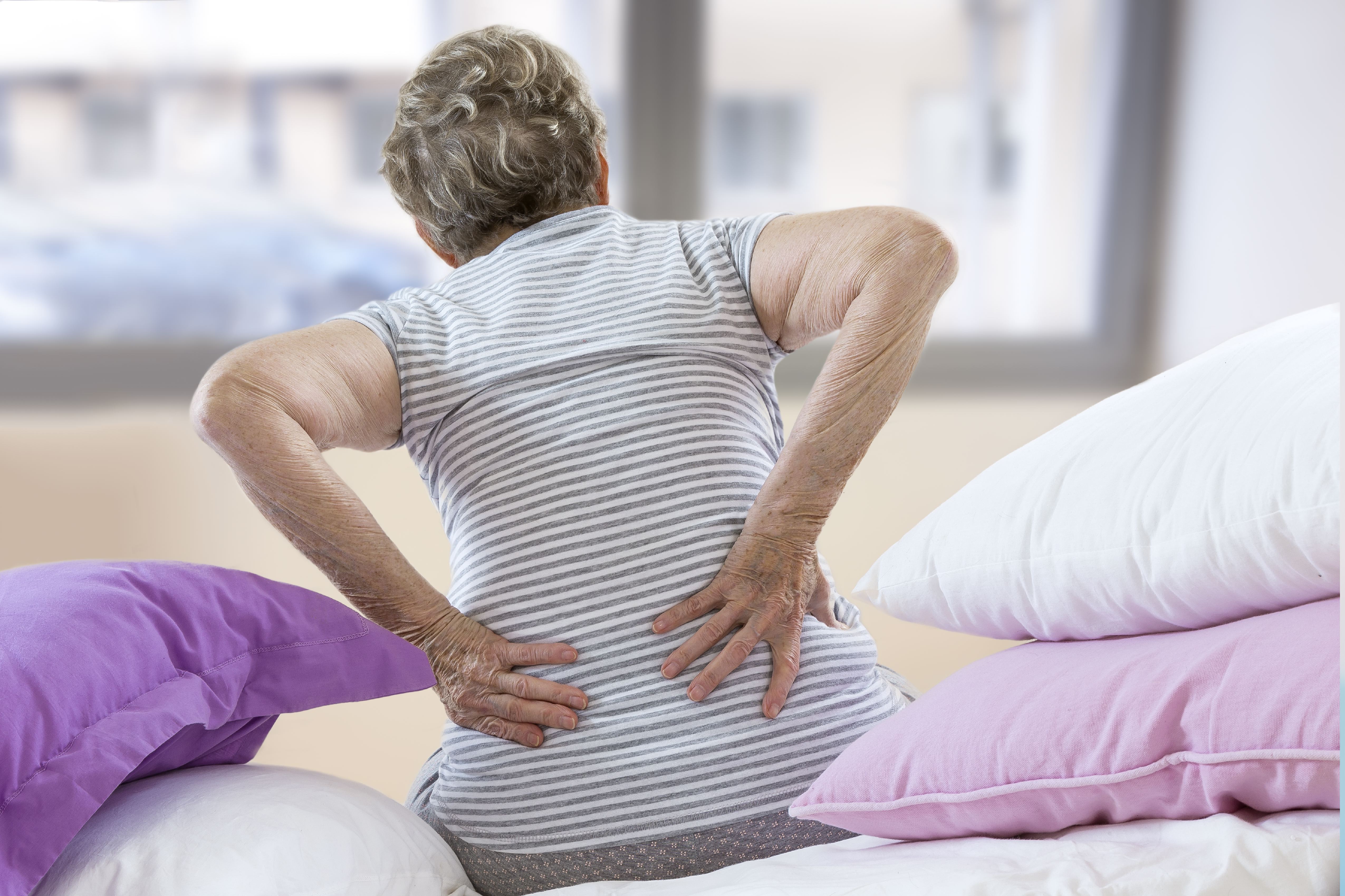 Senior woman suffering from lumbar pain.