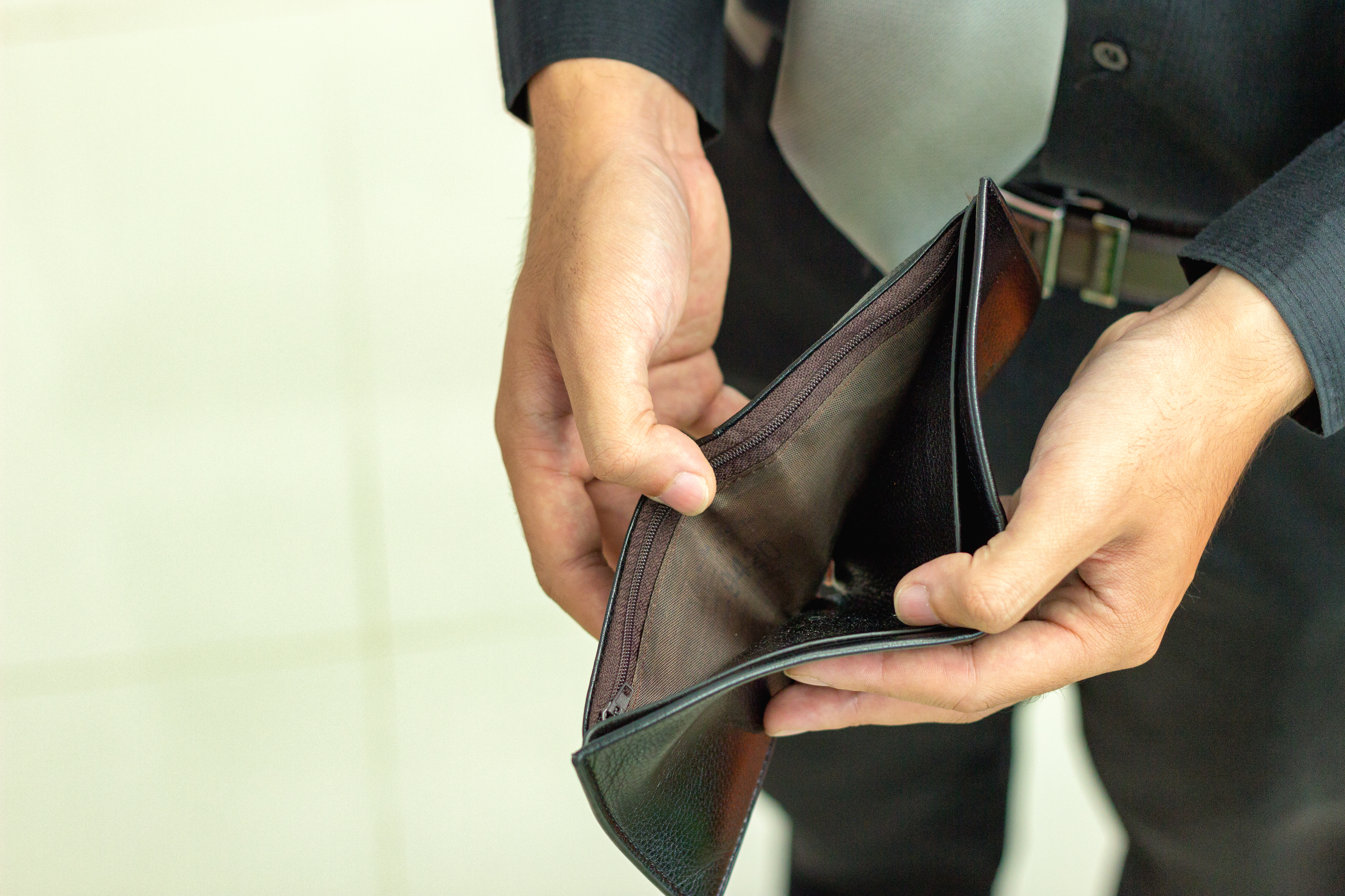 Midsection Of Man Showing Empty Wallet
