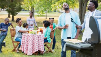 Large African-American family having backyard cookout