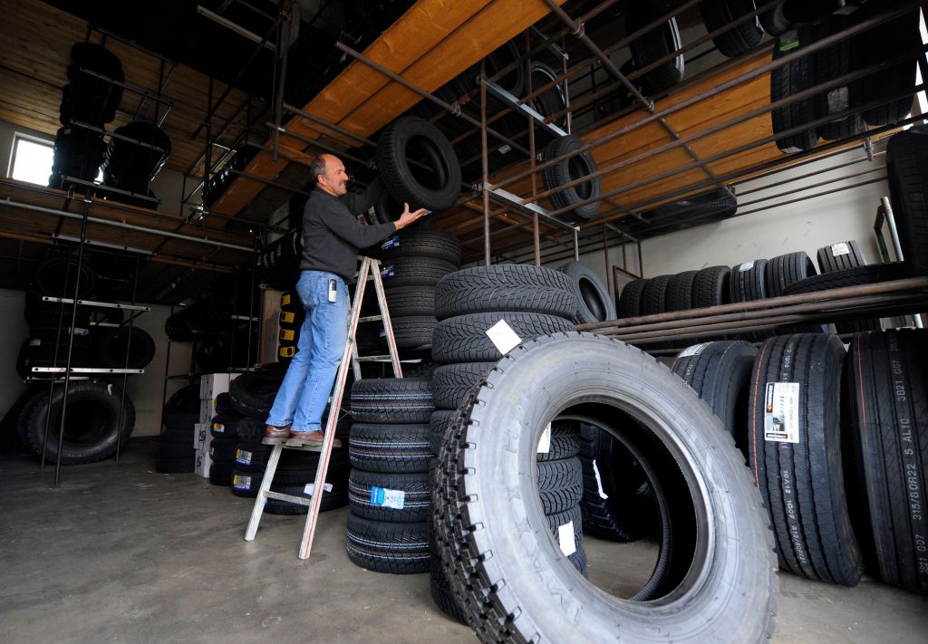 An employee stores new winter tyres in a
