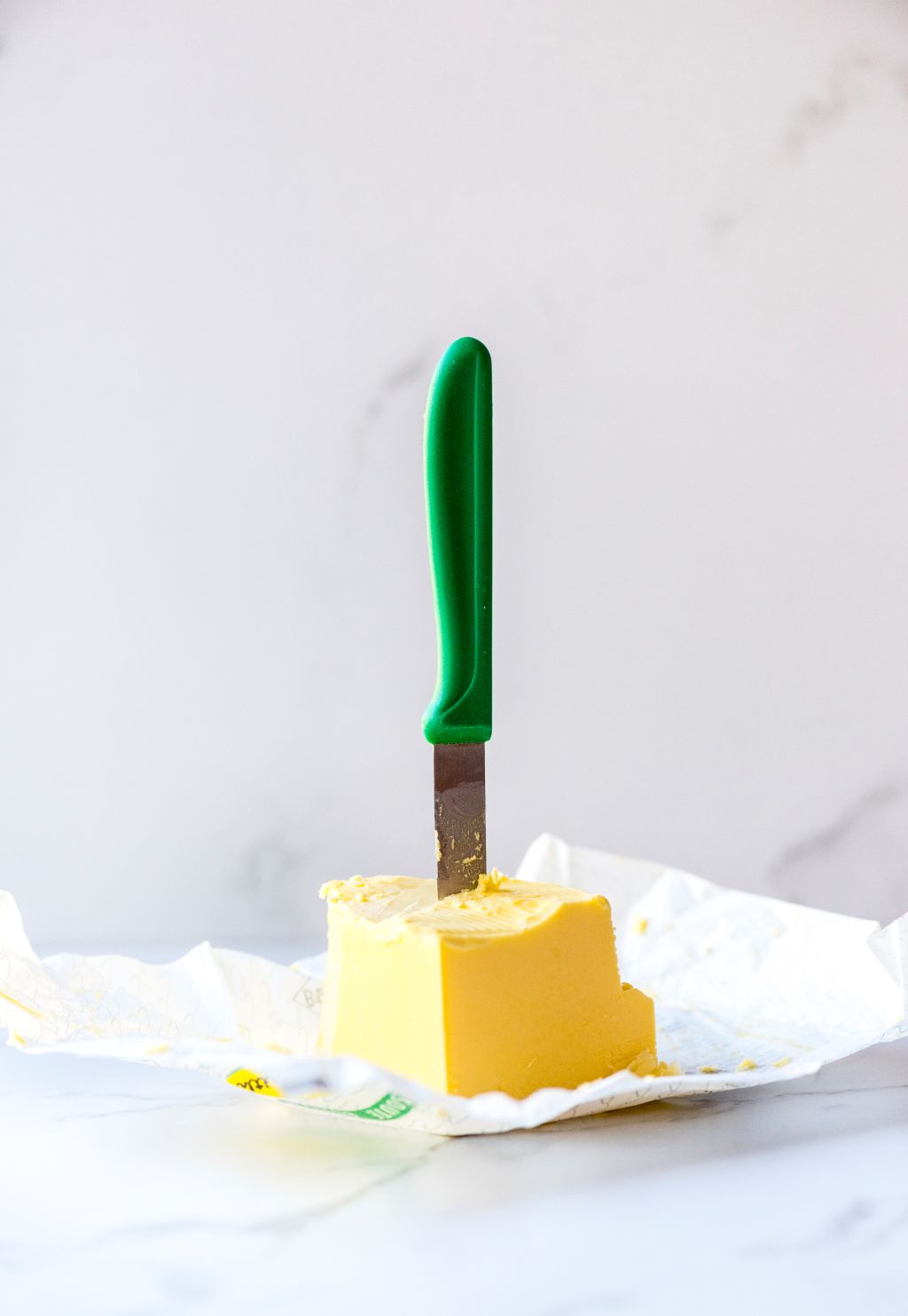 Close-Up Of Kitchen Knife In Butter On Table