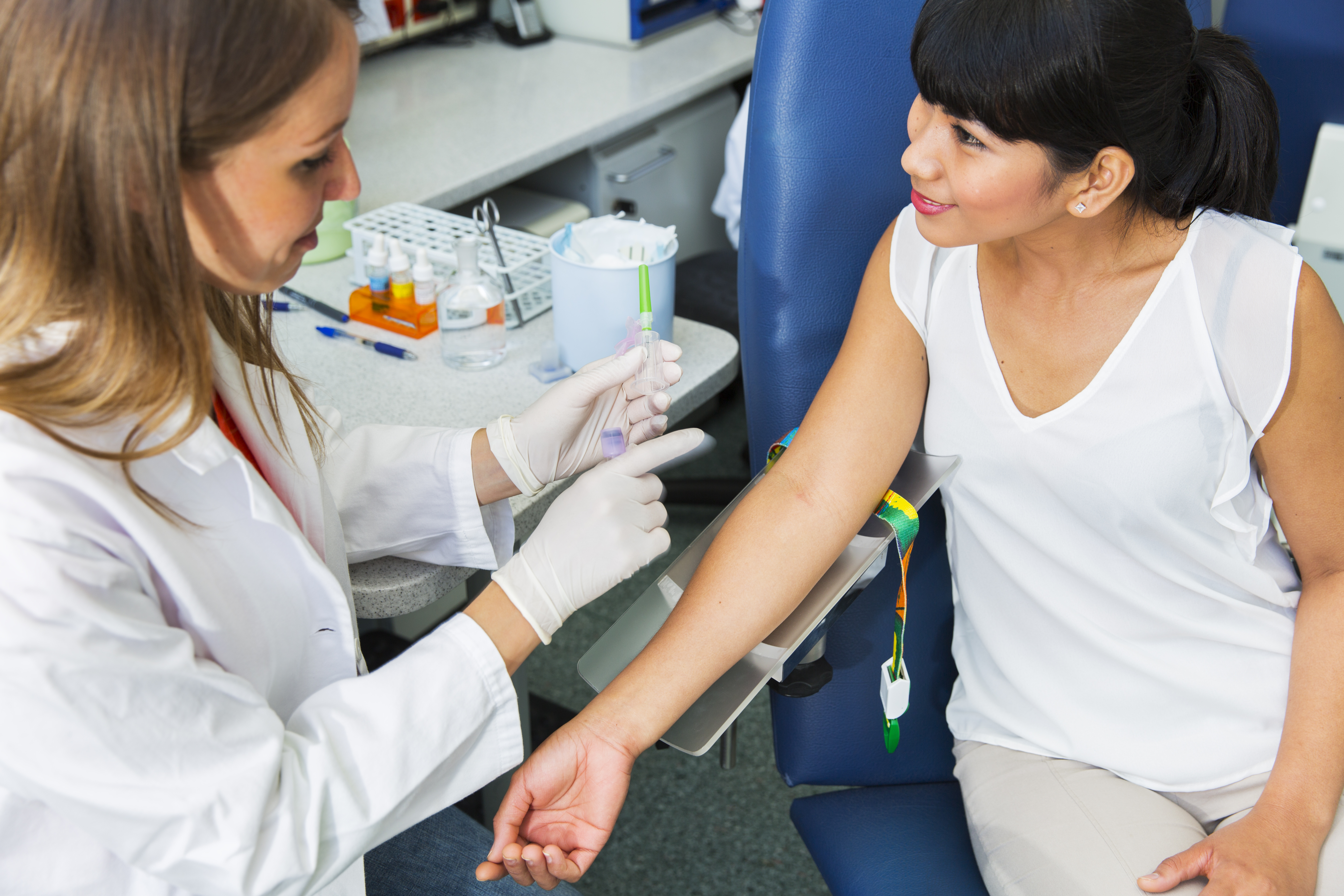 Drawing blood...young doctor prepairing for blood capture