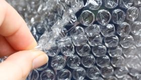 Close-Up Of Cropped Hand Popping Bubble Wrap