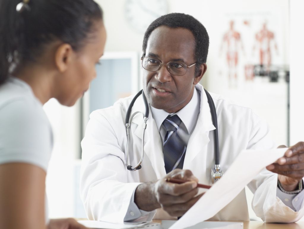 African male doctor talking to patient