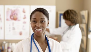Female nurse standing with doctor, focus on nurse