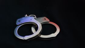 High Angle View Of Hand Cuffs On Black Background