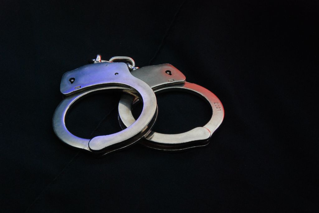 High Angle View Of Hand Cuffs On Black Background
