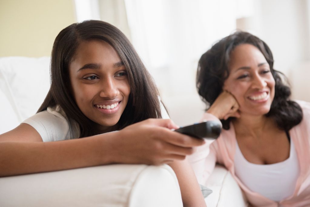 Mother and daughter watching television