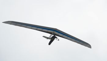 Hang glider against misty sky