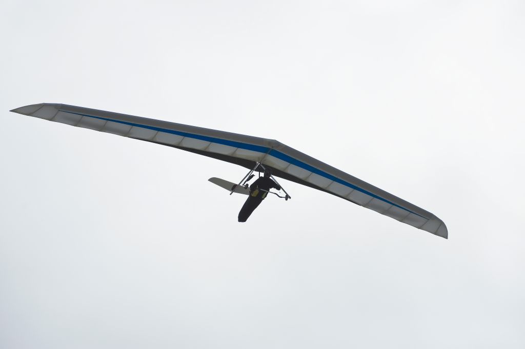 Hang glider against misty sky