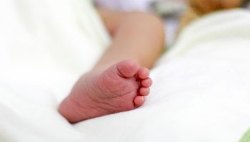Low Section Of Baby On Bed