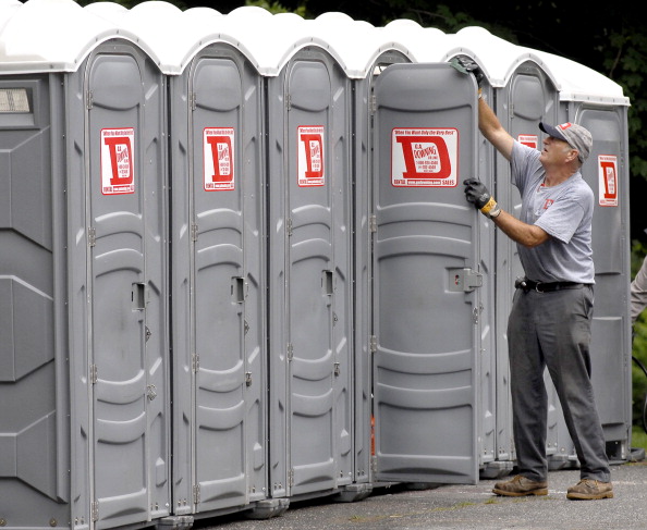 Tony Paine cleans one of 44 porta potty's that he and his crew are installing around Yarmouth today