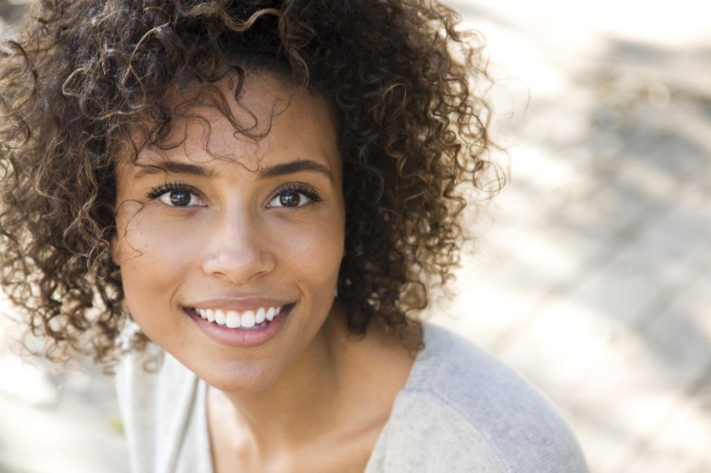 Beautiful woman with curly hair smiling