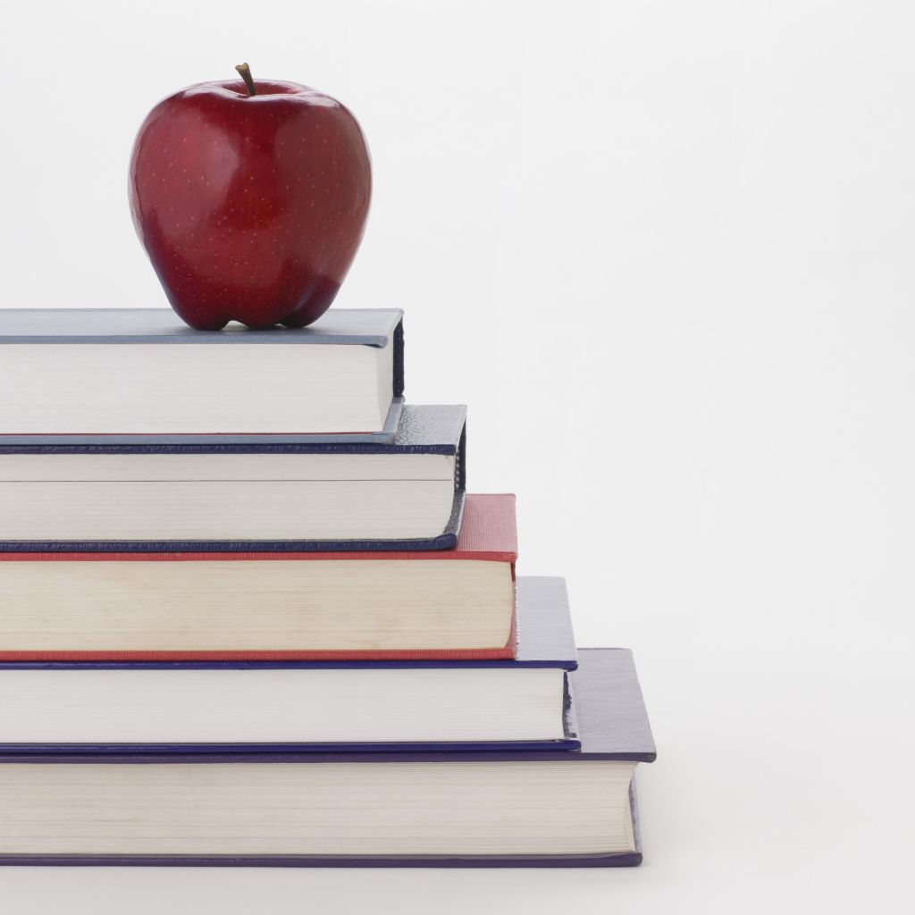Apple and stack of books
