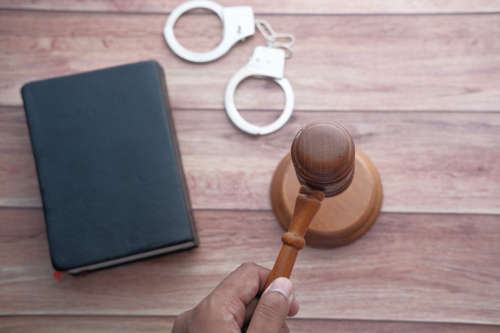 gavel, handcuff and law book
