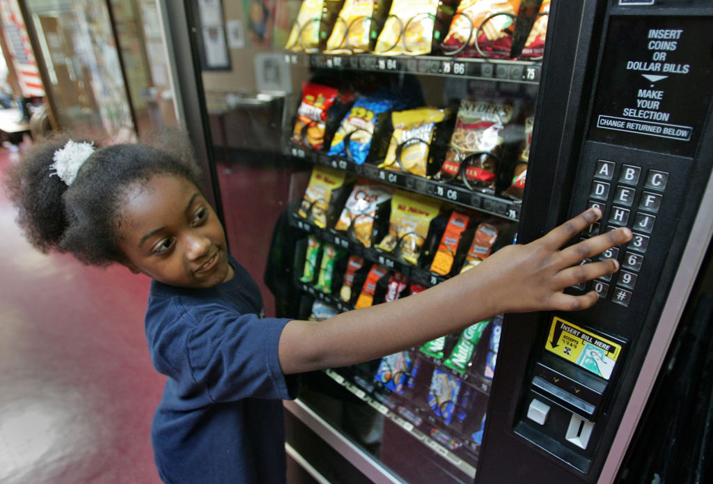 (052907 Somerville, MA) 8 year old Toni Crutchfield of Somerville makes a healthy choice in one of the vending machines at the Somerville Girls & Boys Club Tuesday, May 29, 2007. Staff photo by Matt Stone