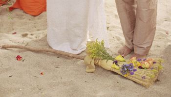 Couple jumping broom at wedding ceremony