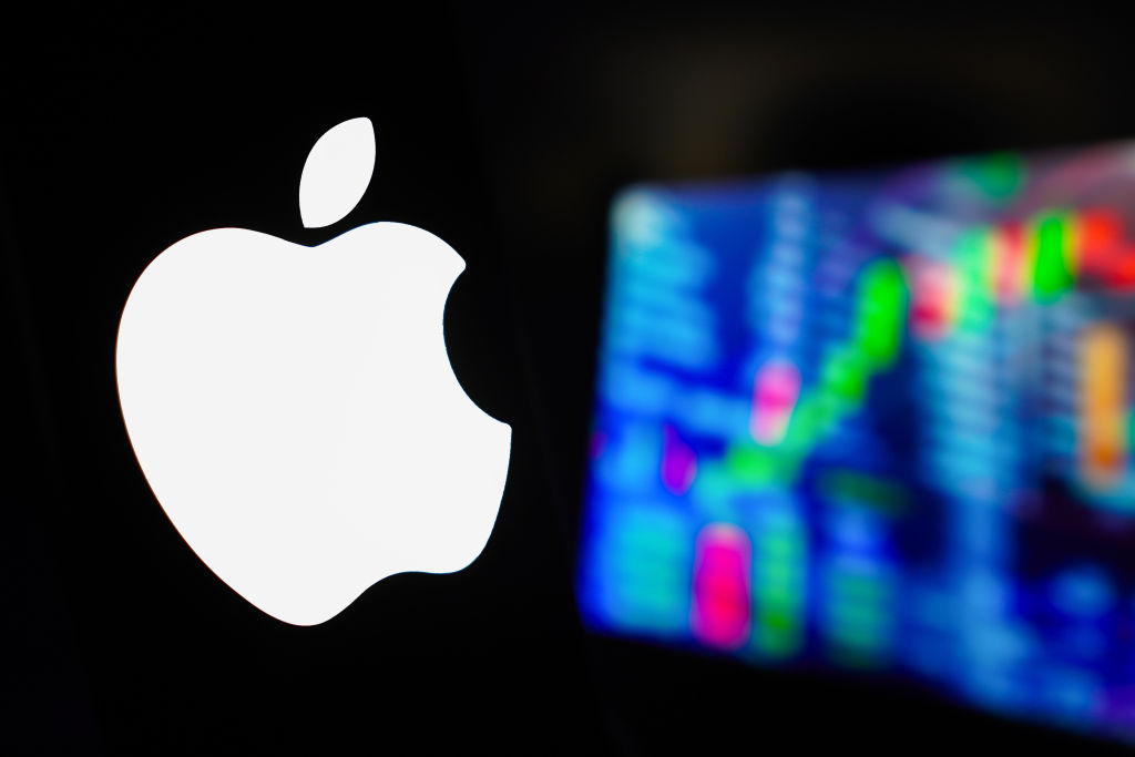 In this photo illustration, the Apple Inc. logo is displayed...