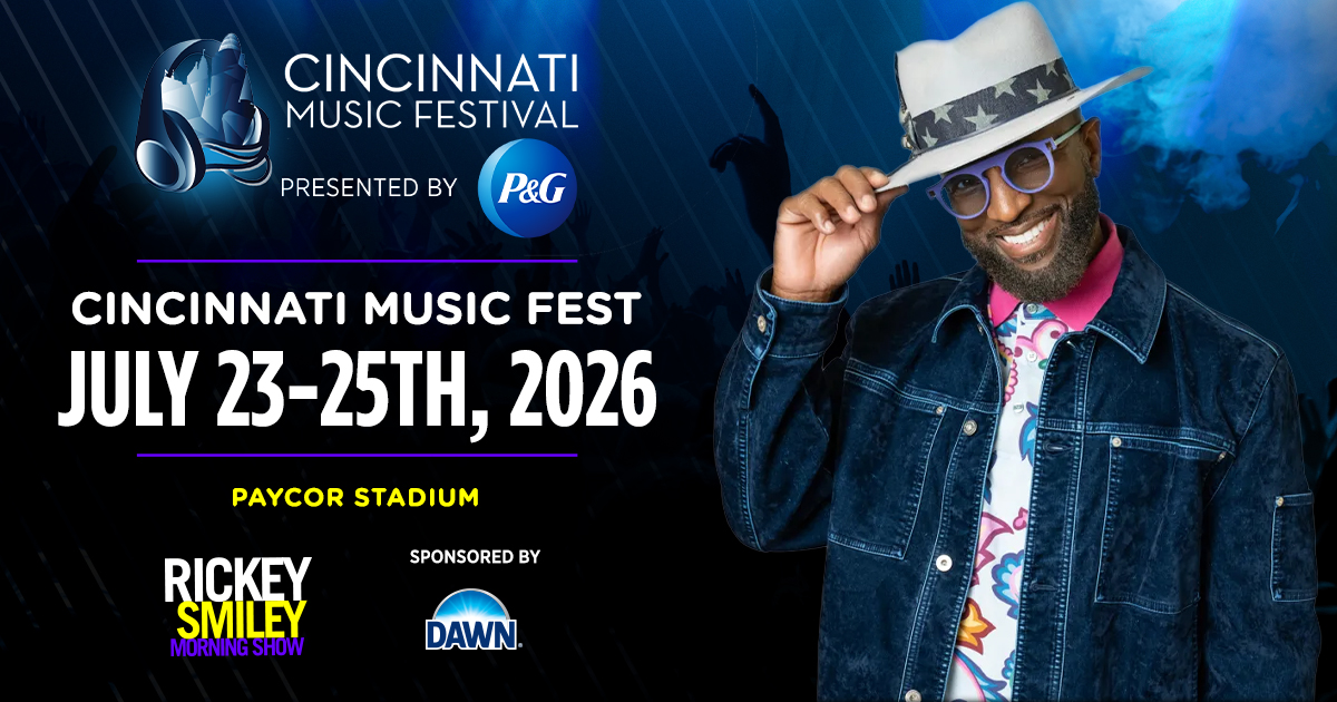 A man wearing a denim jacket, hat, and sunglasses stands in front of a banner for the Cincinnati Music Festival presented by P&G, scheduled for July 23-25, 2026 at Paycor Stadium.