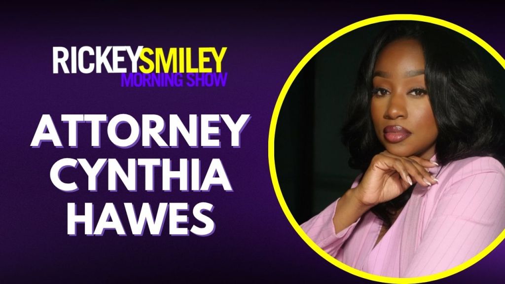 A headshot of a woman with long dark hair wearing a pink shirt, identified as Attorney Cynthia Hawes, on the Rickey Smiley Morning Show.